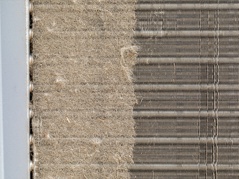 A Condenser coil full of dirt and debris